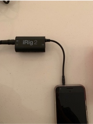 The iRig 2 connected to the headphone jack of a mobile device